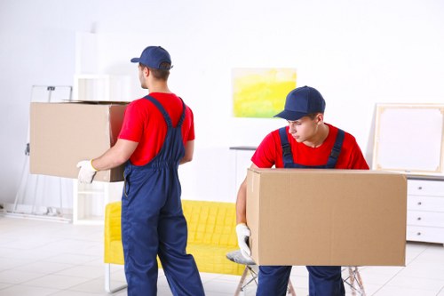 Moving team sorting recyclable packing materials beside a van