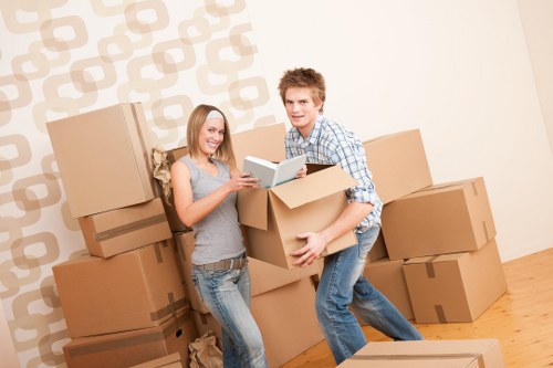 Professional movers carrying furniture during a same day relocation