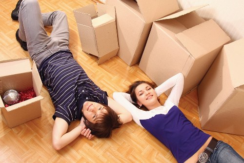 Protected furniture being carried through a flat corridor in Paddington